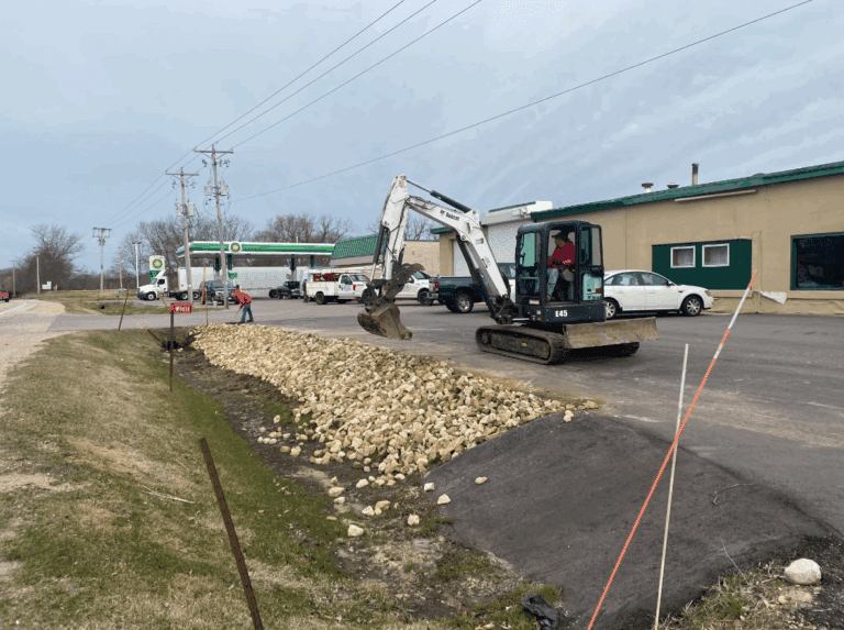 spreading rocks in a new ditch